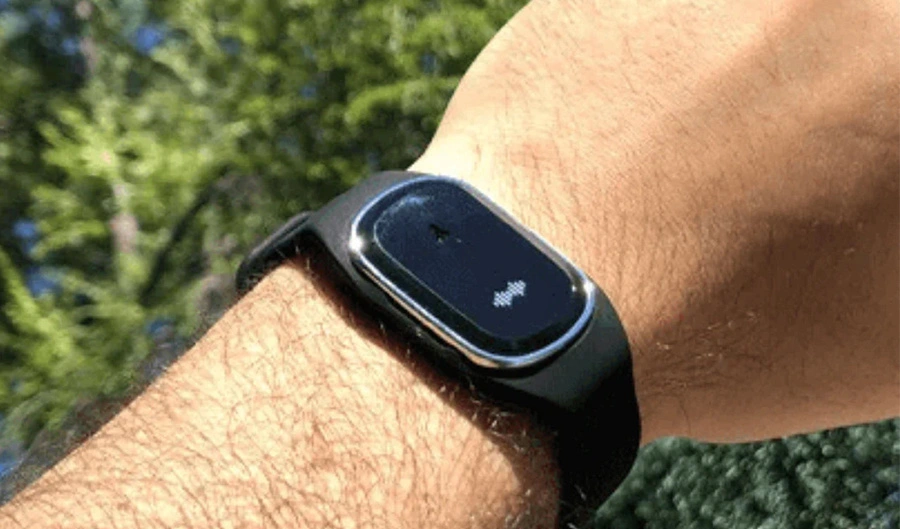 Man's wrist wearing a black MoskitoPro ultrasonic bracelet.