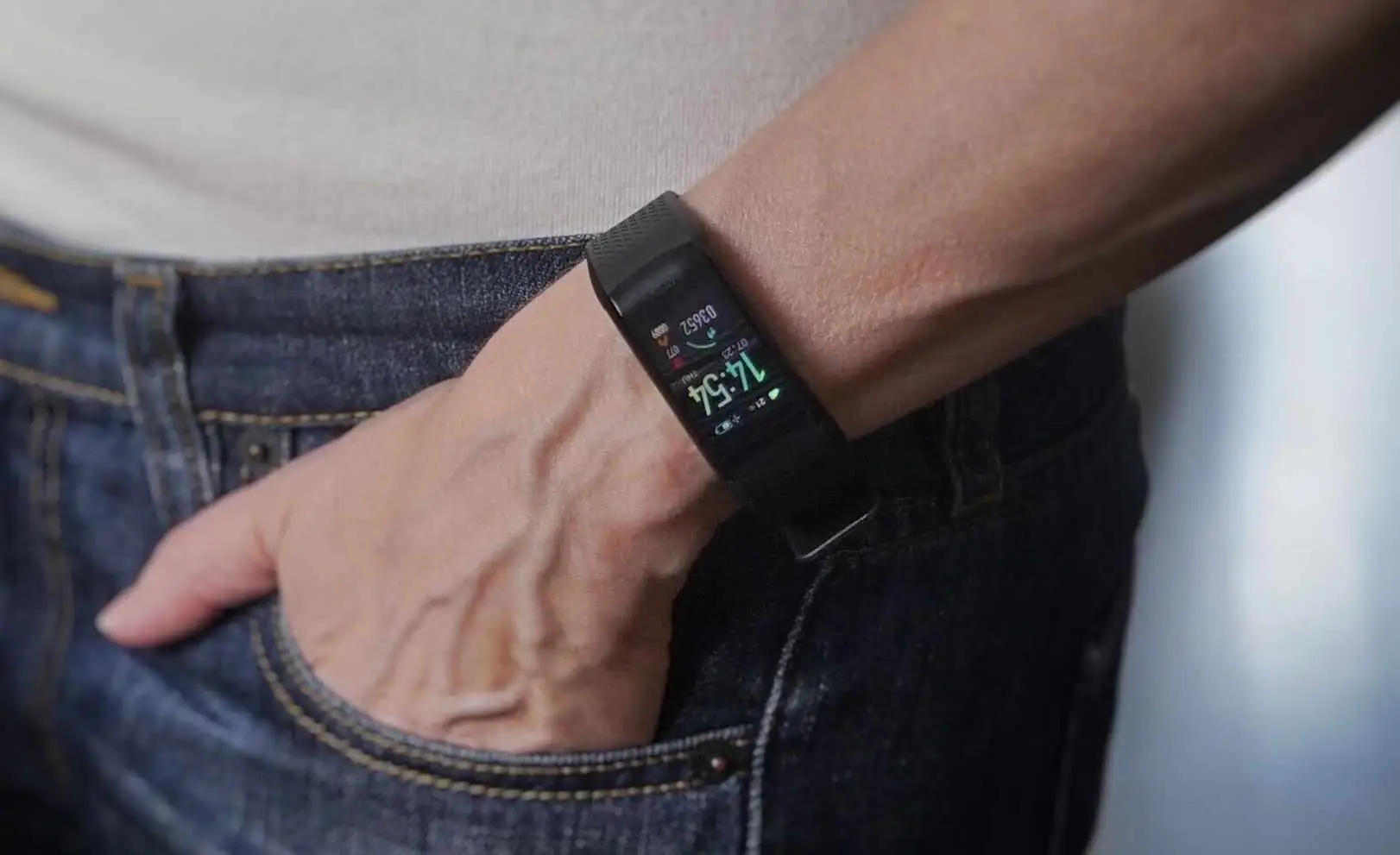 A woman's hand wearing a SmartTrack watch, the watch screen displaying calorie consumption.